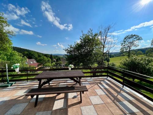a wooden picnic table sitting on a patio at Holiday Home Celine in Velké Svatoňovice