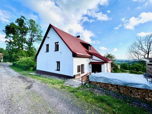 a small white house with a red roof at Holiday Home Celine in Velké Svatoňovice