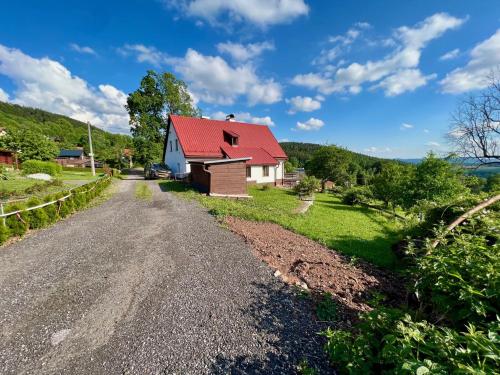 a house with a red roof on a gravel road at Holiday Home Celine in Velké Svatoňovice
