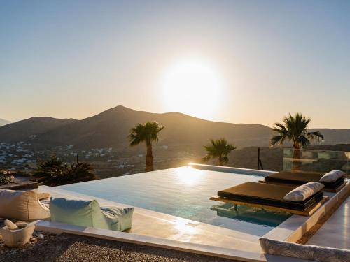 a swimming pool with a view of the mountains at Youtopia Ios Villas in Ios Chora