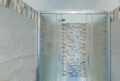 a shower with a glass door in a bathroom at Bellagio, Como Lake Tivano - Lago di Como in Bellagio