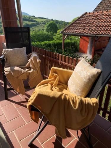 a blanket sitting on a chair on a patio at Pusztavár-Lak in Erdőhorváti