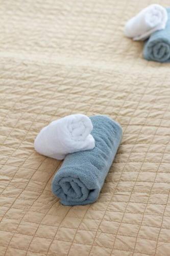 two towels are laying on a bed at Romai Residence Free Parking in Budapest