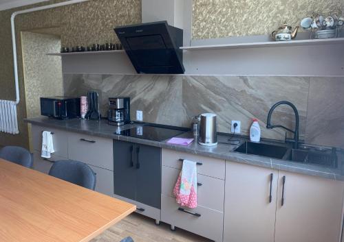 a kitchen with a sink and a counter top at Tian-Shan Guest House in Balykchy