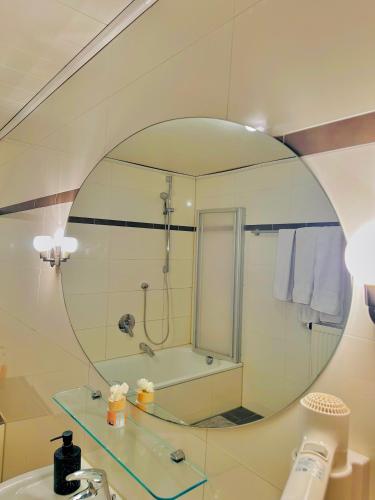 a bathroom with a sink and a mirror at Pilstinger Hof in Pilsting