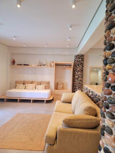 a living room with a bed and a couch at Artis Blue Relax in Himare