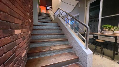 a set of stairs with a brick wall at LIKE Hostel & Bar Lounge in Kaohsiung