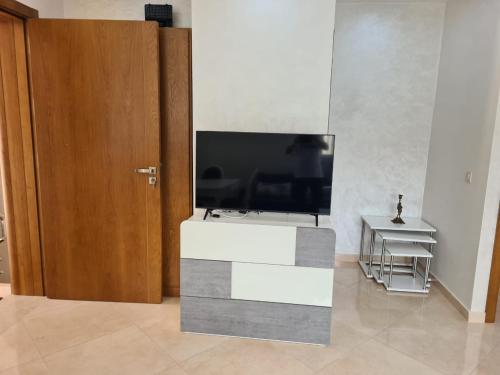a large flat screen tv sitting in a living room at Appartements Horizon in M'diq