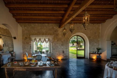 a living room with a table and a large doorway at Castello Camemi in Vizzini