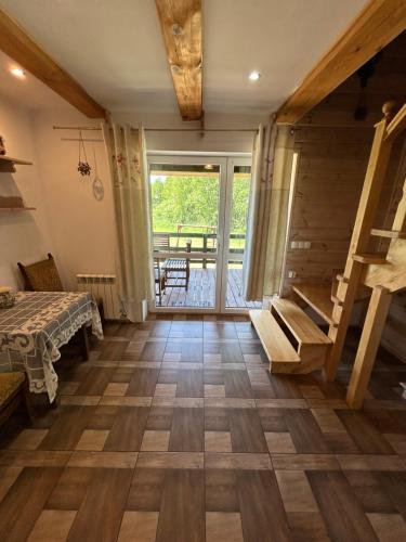 a room with a wooden floor and a staircase at Agroturystyka u Basi i Waldka in Zelwa