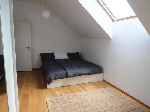 a small bedroom with a bed in a attic at Hiša Eva in Bizovik