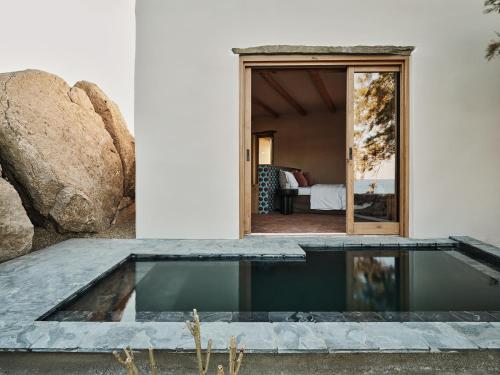 a swimming pool in the middle of a house at The Wild by Interni in Kalafatis