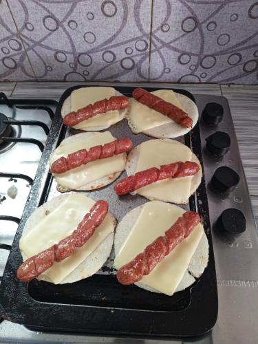 a tray filled with hot dogs and sausages at Hermosa Cabaña Campestre Puente Boyacá in Ventaquemada