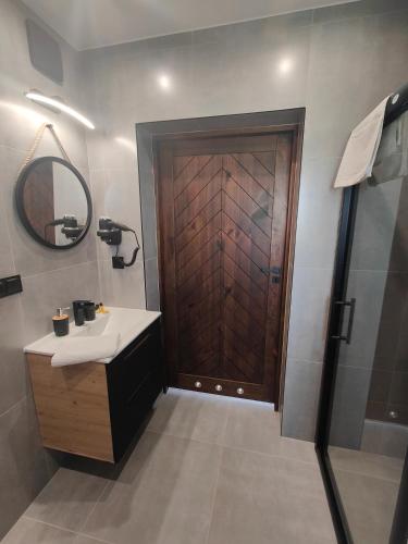 a bathroom with a sink and a wooden door at Na polanie in Czerwienne
