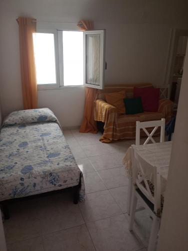 a small bedroom with two beds and a couch at Casa Mariella in Bari
