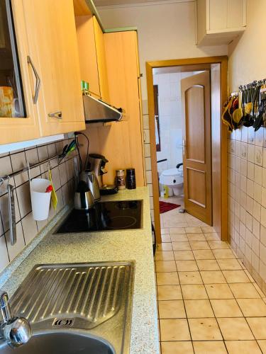a kitchen with a sink and a counter top at Ferienwohnung Juttchen in Roßleben