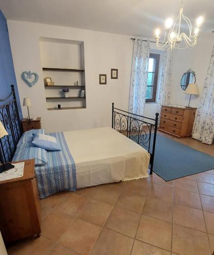 a bedroom with a bed and a dresser in it at Cascina della Chiesa in Ponzone