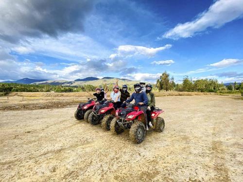 a group of people riding atvs on a dirt road at Hermosa Cabaña Campestre Puente Boyacá in Ventaquemada