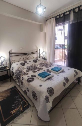 a bedroom with a bed with a black and white comforter at Olga & Dimitris in Kalamata