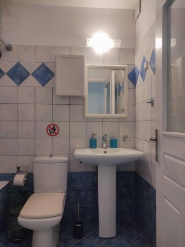 a bathroom with a toilet and a sink at Olga & Dimitris in Kalamata
