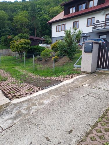 a house with a trash can next to a driveway at MARLEN in Ústí nad Labem