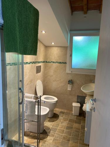 a bathroom with two toilets and a sink and a shower at Vacanze toscane Relax privacy in San Baronto