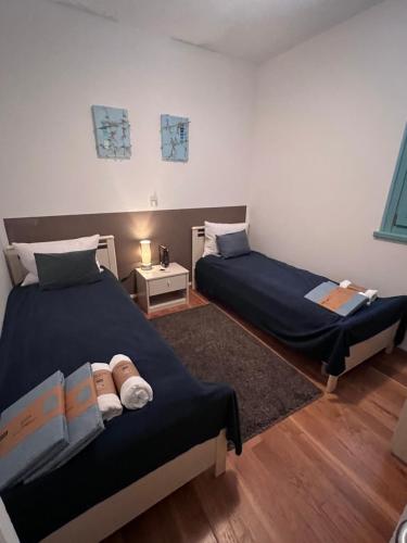ein Schlafzimmer mit 2 Betten und einem Nachttisch mit einer Lampe in der Unterkunft Jovì`s Apartment in Tar