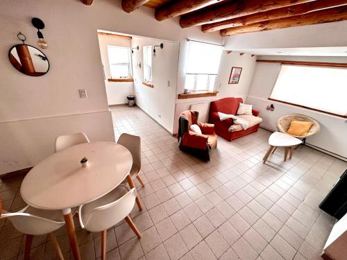 a living room with a table and a couch at Las Araucarias Caviahue in Caviahue