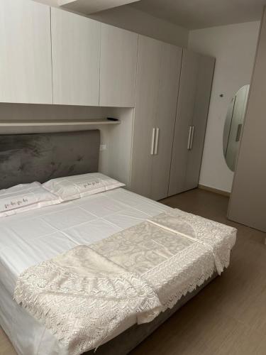 a bedroom with a large bed with white cabinets at Vacanze toscane Relax privacy in San Baronto