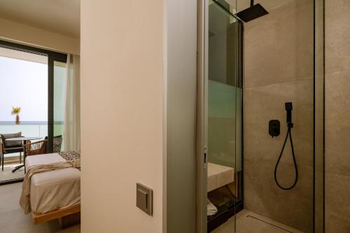 a bathroom with a shower with a glass door at ZEST THASSOS LUXURY RETREAT in Limenaria