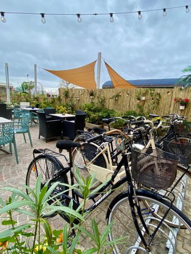 a group of bikes parked in front of a patio at Hotel Amelia in Fano