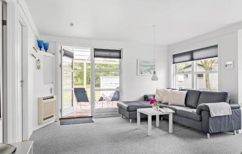 a living room with a couch and a table at Lovely Home In Samsø With Wifi in Onsbjerg