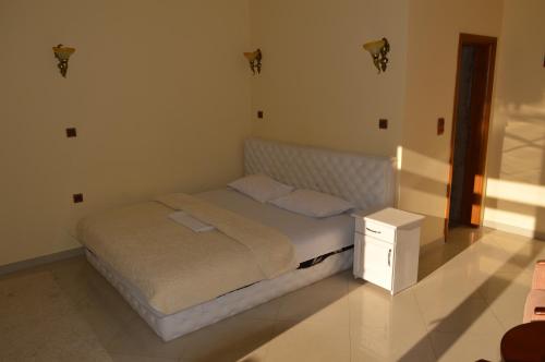 a bedroom with a bed and a night stand at Castle waterfront apartments in Dinoša
