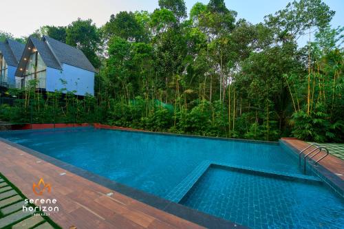 a swimming pool in the backyard of a house at Serene Horizon in Thekkady