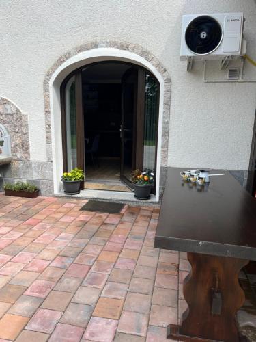 a table in front of a door with a speaker at Apartment & Studio Forest Paradise in Cerkno