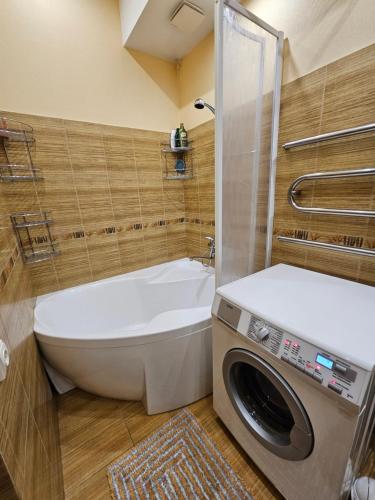 a bathroom with a toilet and a washing machine at Liepu gatve in Klaipėda