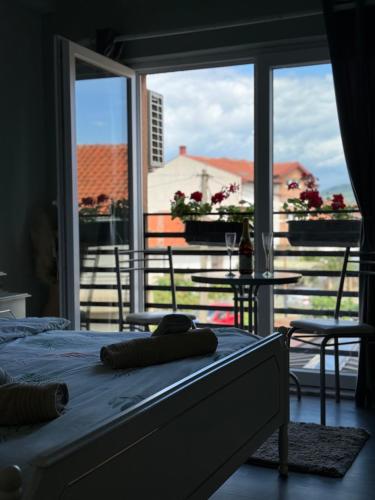 a bedroom with a bed and a large window at Villa Ristovski in Ohrid