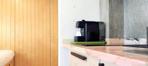 a kitchen with a counter top with a microwave at CQ Coimbra in Coimbra