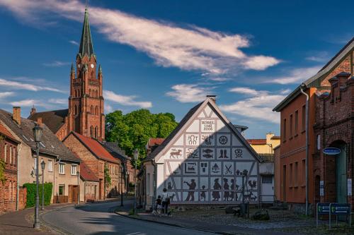 an old building in a town with a clock tower at Lakeview Röbel - Penthouse Am Hafen Röbel in Röbel