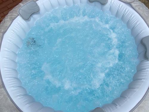 a pool of blue water in a white bucket at Portorož Apartments Franca in Portorož