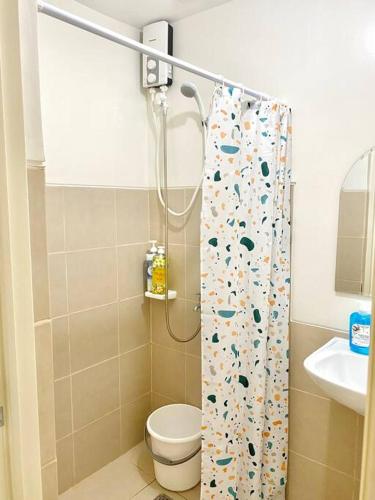 a bathroom with a shower with a toilet and a sink at Stylish Studio in Downtown with Remote Work Setup in Cabaguio