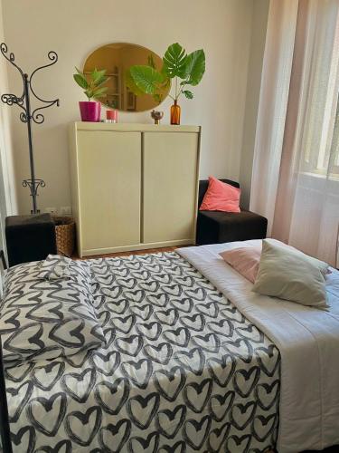 a bedroom with a large bed with a mirror on the wall at Le Camere di Mara in Foligno
