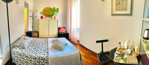 a bedroom with a bed and a table in a room at Le Camere di Mara in Foligno