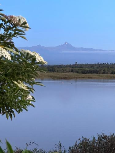 a view of a lake with mountains in the background at Mukima Manor in Nanyuki