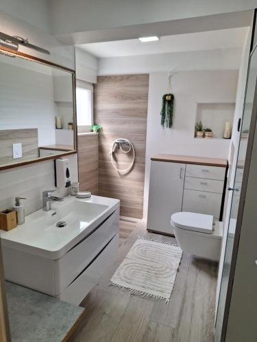 a bathroom with a white sink and a toilet at Traditional town house in Zastražišće