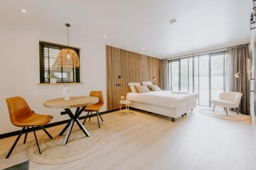 Un dormitorio con una cama y una mesa y sillas. en Bed & Breakfast BBNo9, en Arum