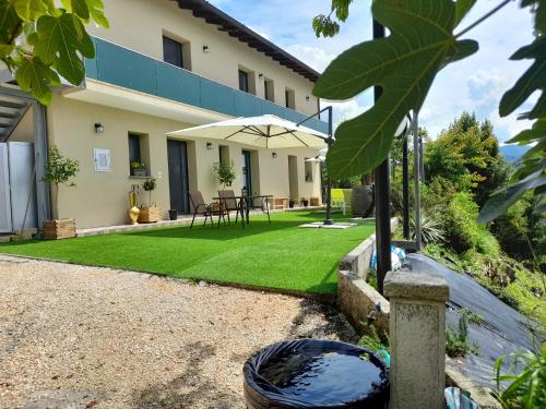 a garden with a lawn in front of a house at L’Oro di Nonna Adele in Udine