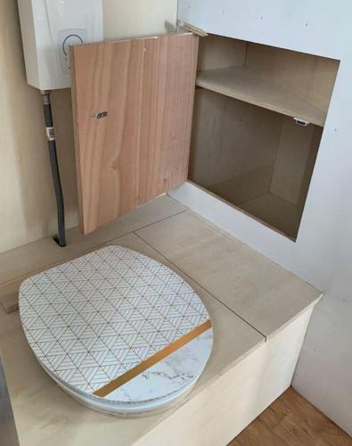 a cabinet with a toilet in a room at Tiny du Verger de la Pommeraye in Morgny-la-Pommeraye