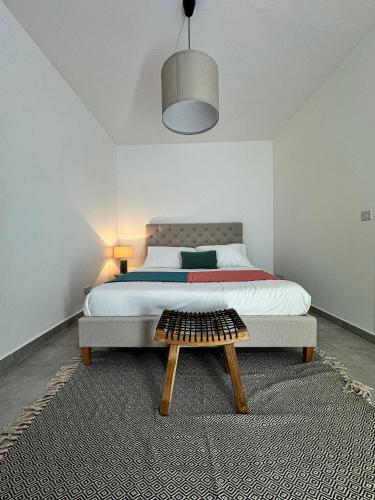 a bedroom with a large bed and a wooden coffee table at La Vie est Belle Penthouse in Tal-Ħriereb