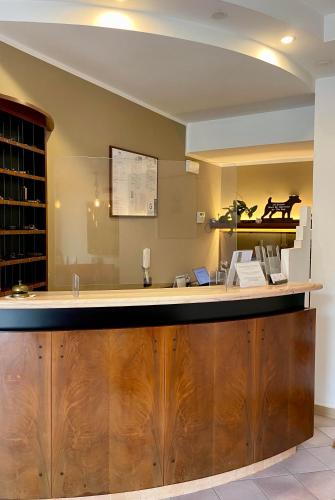 a bar in a wine tasting room with a horse on the wall at Hotel Amelia in Fano